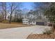 Lovely exterior of house with a red front door, long driveway, and a two-car garage at 545 Birch Ln, Lawrenceville, GA 30044