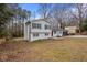 Exterior of home with shuttered windows, a brick chimney, and a well-maintained lawn at 545 Birch Ln, Lawrenceville, GA 30044