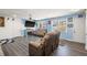 Comfortable living room with gray floors, ceiling fan, and natural light at 545 Birch Ln, Lawrenceville, GA 30044