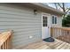 A cozy back door with a wooden deck and neutral-colored siding at 100 Reed St, Canton, GA 30114