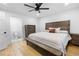 Bedroom featuring a bed, a ceiling fan, hardwood floors, and access to the bathroom at 100 Reed St, Canton, GA 30114