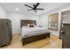 Bedroom with hardwood floors, ceiling fan, shuttered window, and natural light at 100 Reed St, Canton, GA 30114