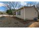 Side view of well-maintained home with manicured lawn and covered porch at 100 Reed St, Canton, GA 30114
