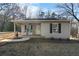 Charming exterior view of a single-story home featuring a cozy porch with rocking chairs at 100 Reed St, Canton, GA 30114