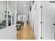Hallway featuring hardwood floors, natural light, and access to other rooms in the house at 100 Reed St, Canton, GA 30114