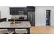 Sleek modern kitchen featuring stainless steel appliances and a spacious island with seating at 100 Reed St, Canton, GA 30114