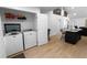 A laundry room with a washer, dryer, and cabinets, showcasing practicality and storage at 100 Reed St, Canton, GA 30114