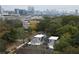 An aerial view of a modern home in a lush neighborhood with the Atlanta skyline in the background at 1186B Francis Nw St, Atlanta, GA 30318