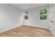Bedroom featuring hardwood floors, white trim, and large windows that allow natural light to fill the space at 1186B Francis Nw St, Atlanta, GA 30318