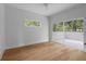Bright bedroom featuring hardwood floors, neutral walls, window, sliding glass doors to a private balcony at 1186B Francis Nw St, Atlanta, GA 30318