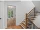 Elegant entryway featuring hardwood floors and a staircase with black metal spindles and wood banister at 1186B Francis Nw St, Atlanta, GA 30318