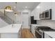 Beautiful kitchen features stainless steel appliances, quartz countertops, and stylish pendant lights at 1186B Francis Nw St, Atlanta, GA 30318