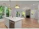 Open kitchen concept with stainless steel appliances, an island, and a seamless transition to the living area at 1186B Francis Nw St, Atlanta, GA 30318