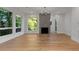 Bright living room featuring hardwood floors, fireplace, and multiple windows with verdant backyard views at 1186B Francis Nw St, Atlanta, GA 30318