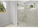 Elegant shower with frameless glass door, mosaic tile floor, bronze fixtures and window at 1186B Francis Nw St, Atlanta, GA 30318