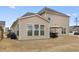 View of the backyard with patio, dining set, lush lawn, and privacy fence at 250 Riverclub Rd, Acworth, GA 30101