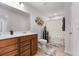 Well-lit bathroom features double sinks, wood vanity, and neutral tile flooring at 250 Riverclub Rd, Acworth, GA 30101
