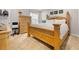 Bright bedroom features an ornate wooden bed, dresser, and neutral carpet at 250 Riverclub Rd, Acworth, GA 30101