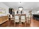 Formal dining area featuring a modern chandelier, hardwood floors, and an open view of the stylish kitchen at 250 Riverclub Rd, Acworth, GA 30101