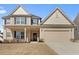 Inviting two-story home featuring a covered porch, neutral siding, and an attached two-car garage at 250 Riverclub Rd, Acworth, GA 30101