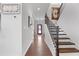 Inviting foyer with hardwood floors, staircase, and stylish decor, creating a warm welcome at 250 Riverclub Rd, Acworth, GA 30101