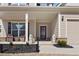 Inviting front porch with decorative lions, seating, and a stained glass front door at 250 Riverclub Rd, Acworth, GA 30101