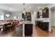 Bright, open kitchen with a center island, dark wood cabinets, granite countertops, and adjacent dining area at 250 Riverclub Rd, Acworth, GA 30101