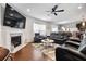 Open-concept living room featuring a fireplace, hardwood floors, and a view into the kitchen at 250 Riverclub Rd, Acworth, GA 30101