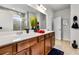 Spacious main bathroom with dual sinks, wood cabinetry, and modern lighting, blending functionality and style at 250 Riverclub Rd, Acworth, GA 30101