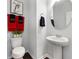 Elegant powder room with pedestal sink, oval mirror, and decorative towel accents, offering a stylish touch at 250 Riverclub Rd, Acworth, GA 30101