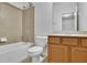 Well-lit bathroom with a tub-shower combo and a vanity with wooden cabinets providing storage at 4050 Preserve Crossing Ln, Cumming, GA 30040