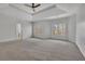 Large bedroom with lots of space, neutral carpet, ceiling fan, and view of the outdoors at 4050 Preserve Crossing Ln, Cumming, GA 30040