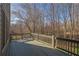 Wooden deck with railing offering peaceful views of the surrounding natural landscape at 4050 Preserve Crossing Ln, Cumming, GA 30040