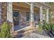Inviting front porch with stone accents and an elegant entrance at 4050 Preserve Crossing Ln, Cumming, GA 30040