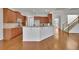 Open kitchen with breakfast bar, granite countertops, and easy access to the staircase at 4050 Preserve Crossing Ln, Cumming, GA 30040