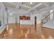Open-concept living room with hardwood floors, coffered ceiling, and seamless flow to the kitchen at 4050 Preserve Crossing Ln, Cumming, GA 30040