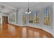 Bright living room with many windows offering wooded views and a glass door to a deck at 4050 Preserve Crossing Ln, Cumming, GA 30040