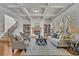 Cozy living room featuring a stone fireplace, built-in bookshelves, and coffered ceiling at 4050 Preserve Crossing Ln, Cumming, GA 30040