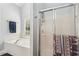 Well lit bathroom with a jacuzzi tub under a window, adjacent to glass shower at 306 Blake Dr, Canton, GA 30114