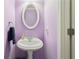 Small half bath with pedestal sink and purple paint at 306 Blake Dr, Canton, GA 30114