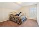 Bright bedroom with neutral walls, patterned bedding, and a large sunny window at 306 Blake Dr, Canton, GA 30114