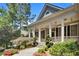 Charming home with stone steps and a landscaped front yard leading to covered porch at 306 Blake Dr, Canton, GA 30114