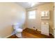 Bathroom with toilet, vanity, window, and hardwood flooring at 6093 Venetian Way, Mableton, GA 30126