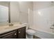 Bathroom featuring vanity with dark wood cabinet, combination tub and shower, and toilet at 920 Sublime Trl, Canton, GA 30114