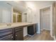 Bathroom featuring double sinks, dark wood cabinets, and glass shower at 920 Sublime Trl, Canton, GA 30114