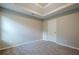 Bedroom with a tray ceiling, neutral walls, plush carpet, and an interior door at 920 Sublime Trl, Canton, GA 30114