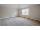 Carpeted bedroom featuring a window, neutral walls, and baseboards at 920 Sublime Trl, Canton, GA 30114