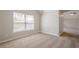 Carpeted bedroom with neutral walls and trim has a window and doorway to another room at 920 Sublime Trl, Canton, GA 30114