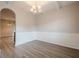 Open dining space with elegant wainscoting, a modern chandelier, and hardwood floors at 920 Sublime Trl, Canton, GA 30114