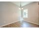 Dining room features wood floors, a modern chandelier, and a bright window at 920 Sublime Trl, Canton, GA 30114
